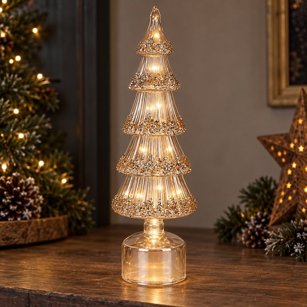 34cm Amber Spinning light up Tree decoration on a wooden table surrounded by Christmas décor